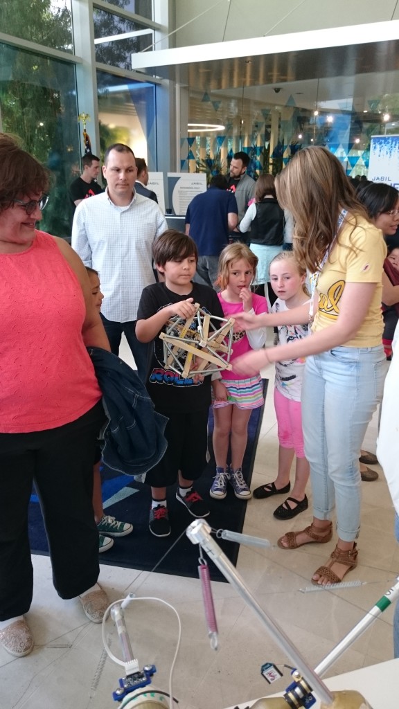 BEST Labber Mallory Daly explains "tensegrity" to a group of children at the 2016 Robot Block Party