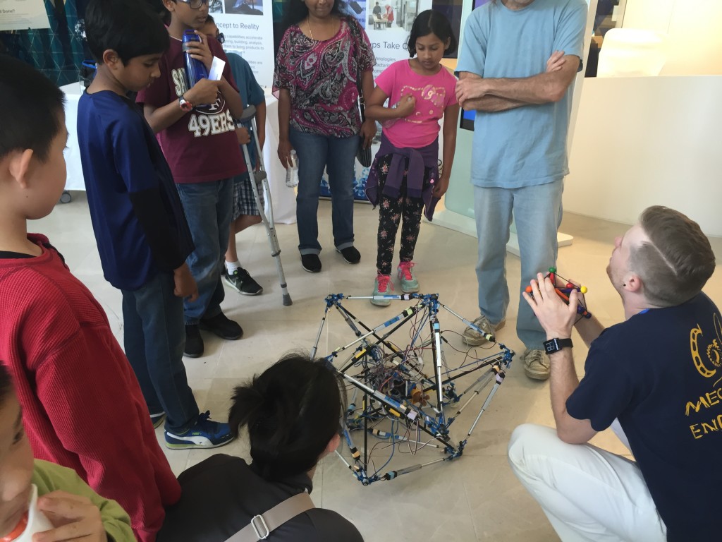 BEST Labber Drew Sabelhaus explains a tensegrity robot to attendees of the 2016 Robot Block Party
